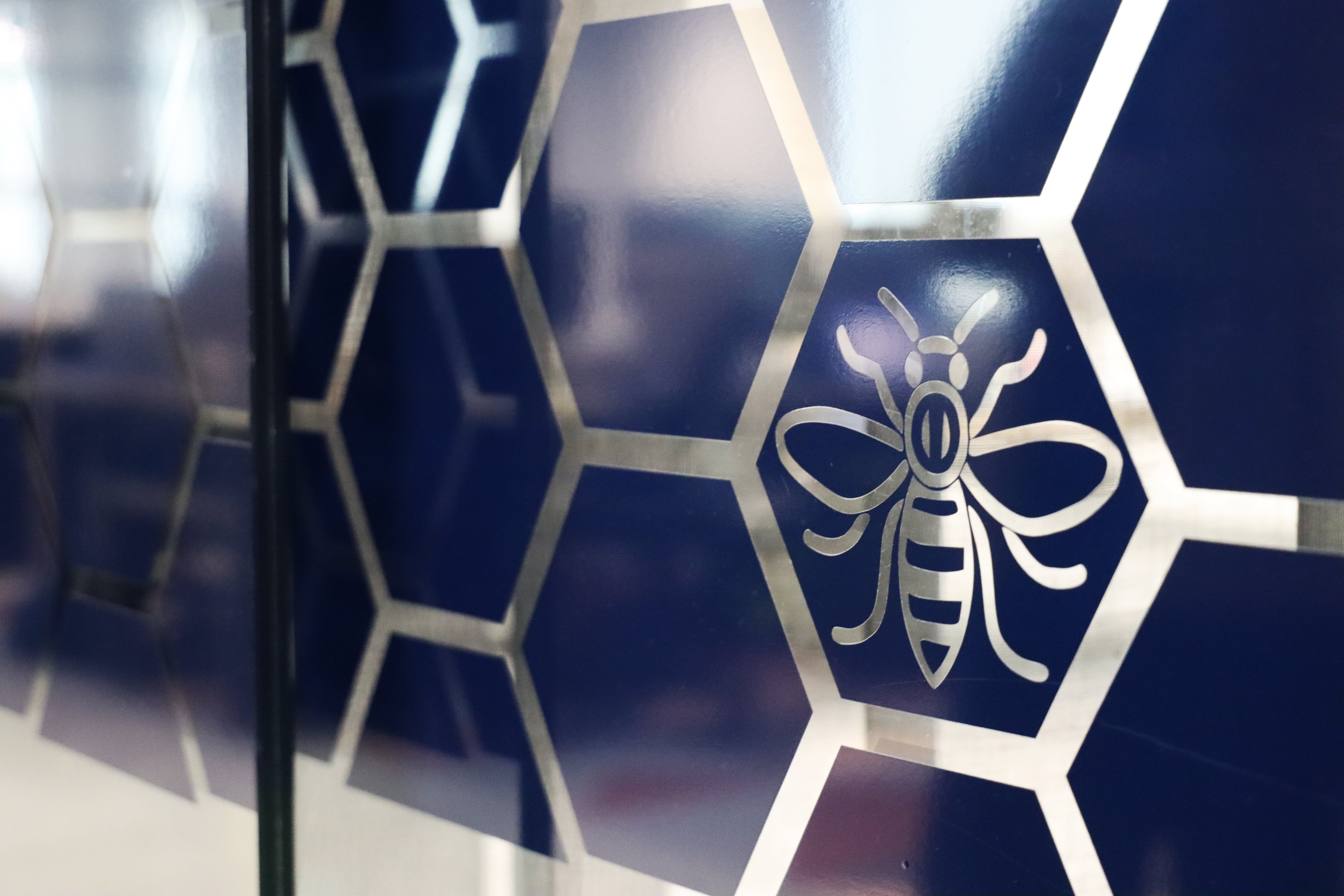 The interior of GCHQ's Heron House office with the Manchester 'worker bee' icon clear on the wall