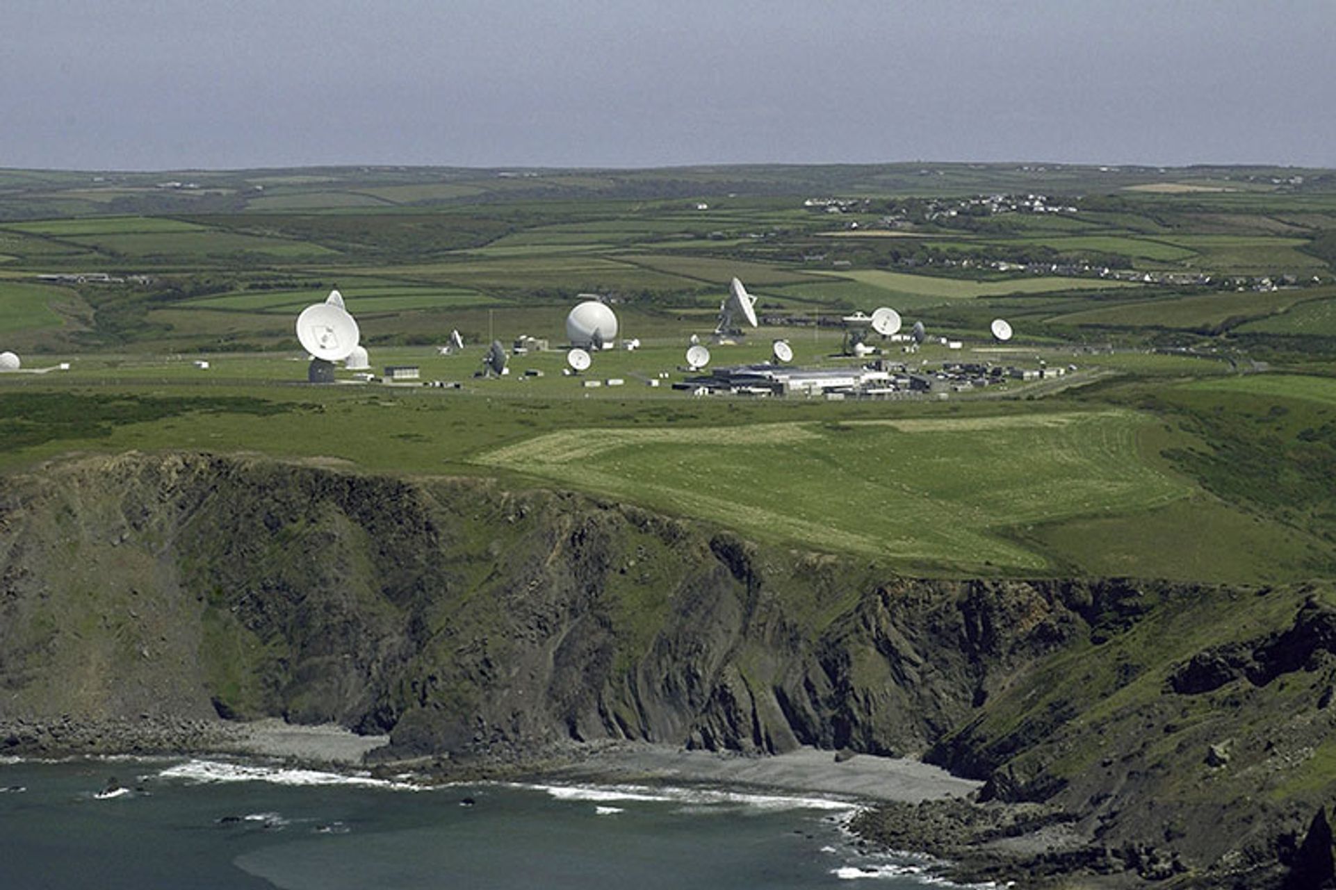 A satellite dish at GCHQ's bude station lit up in red to resemble a poppy