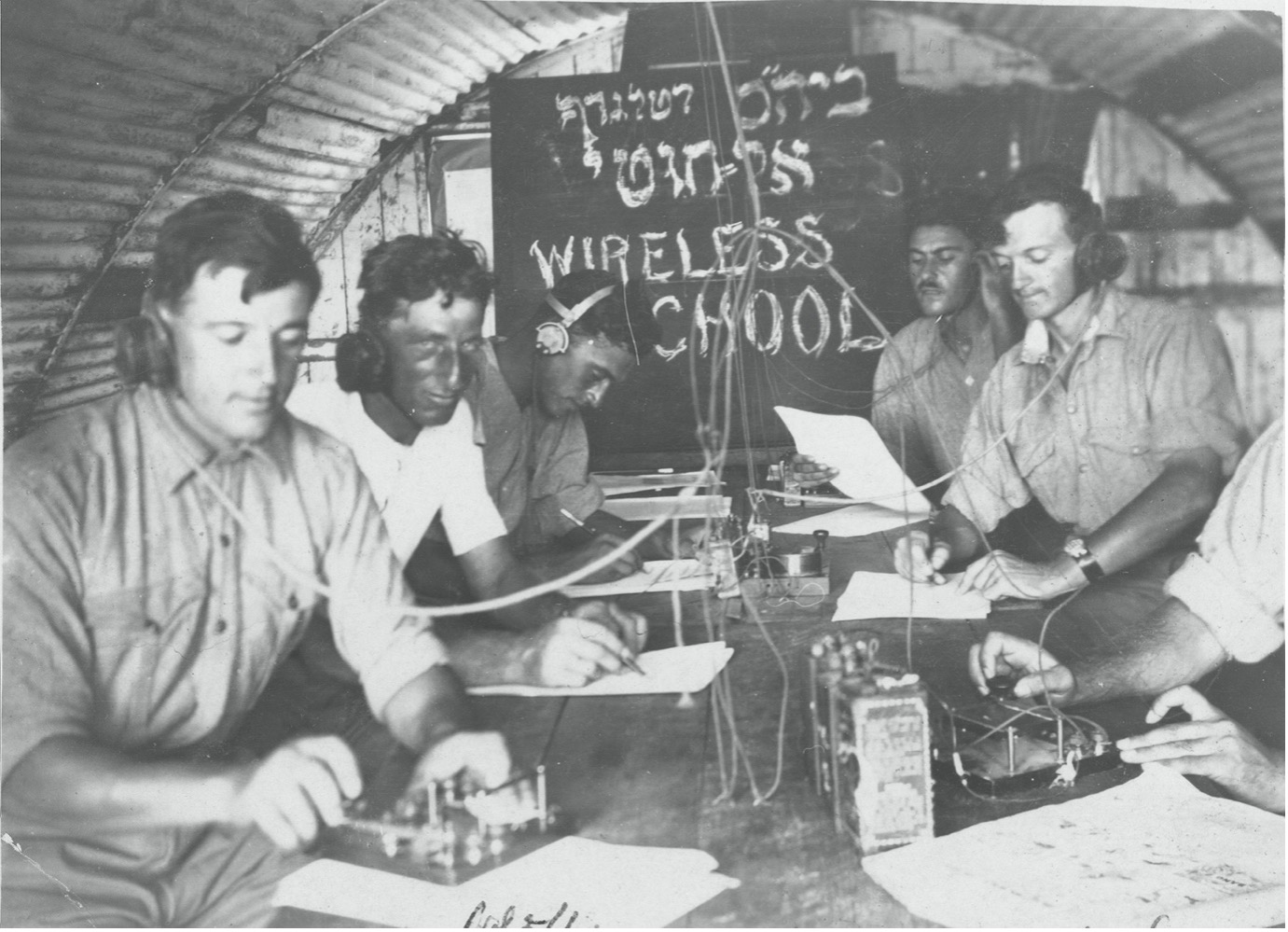 Six people undergoing Morse training at a telegraph school.