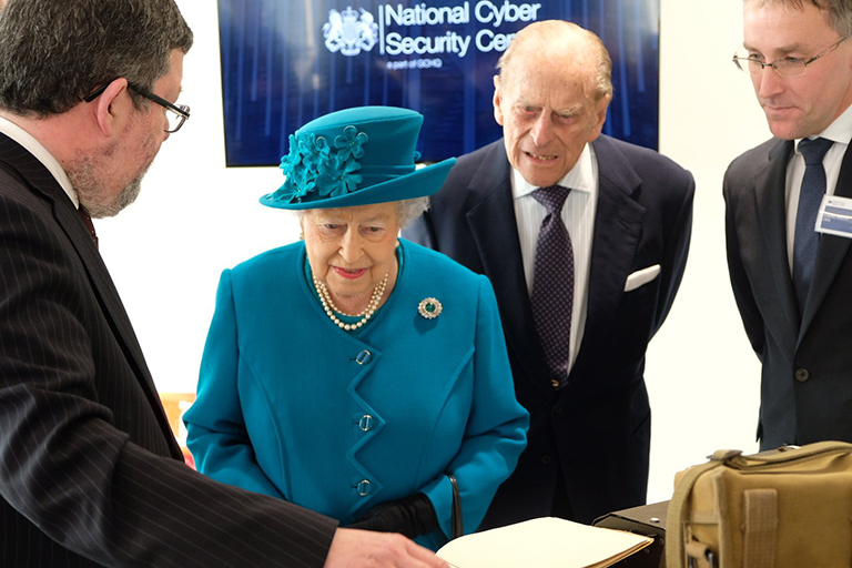 Her Majesty The Queen being shown documents alongside the Duke of Edinburgh