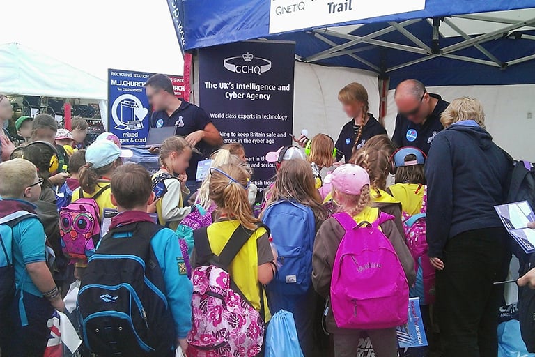 Our staff giving out small prizes when the children solved the puzzle. There's a huge crowd of kids!