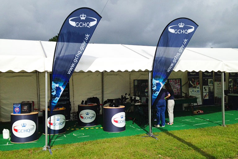 Stands and flags with the GCHQ logo on
