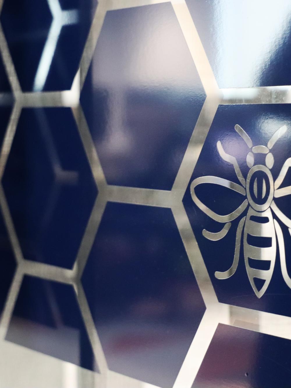 The interior of GCHQ's Heron House office with the Manchester 'worker bee' icon clear on the wall