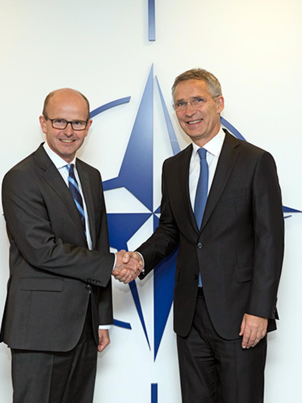 Director GCHQ Jeremy Fleming and NATO General Secretary Jens Stoltenberg shaking hands