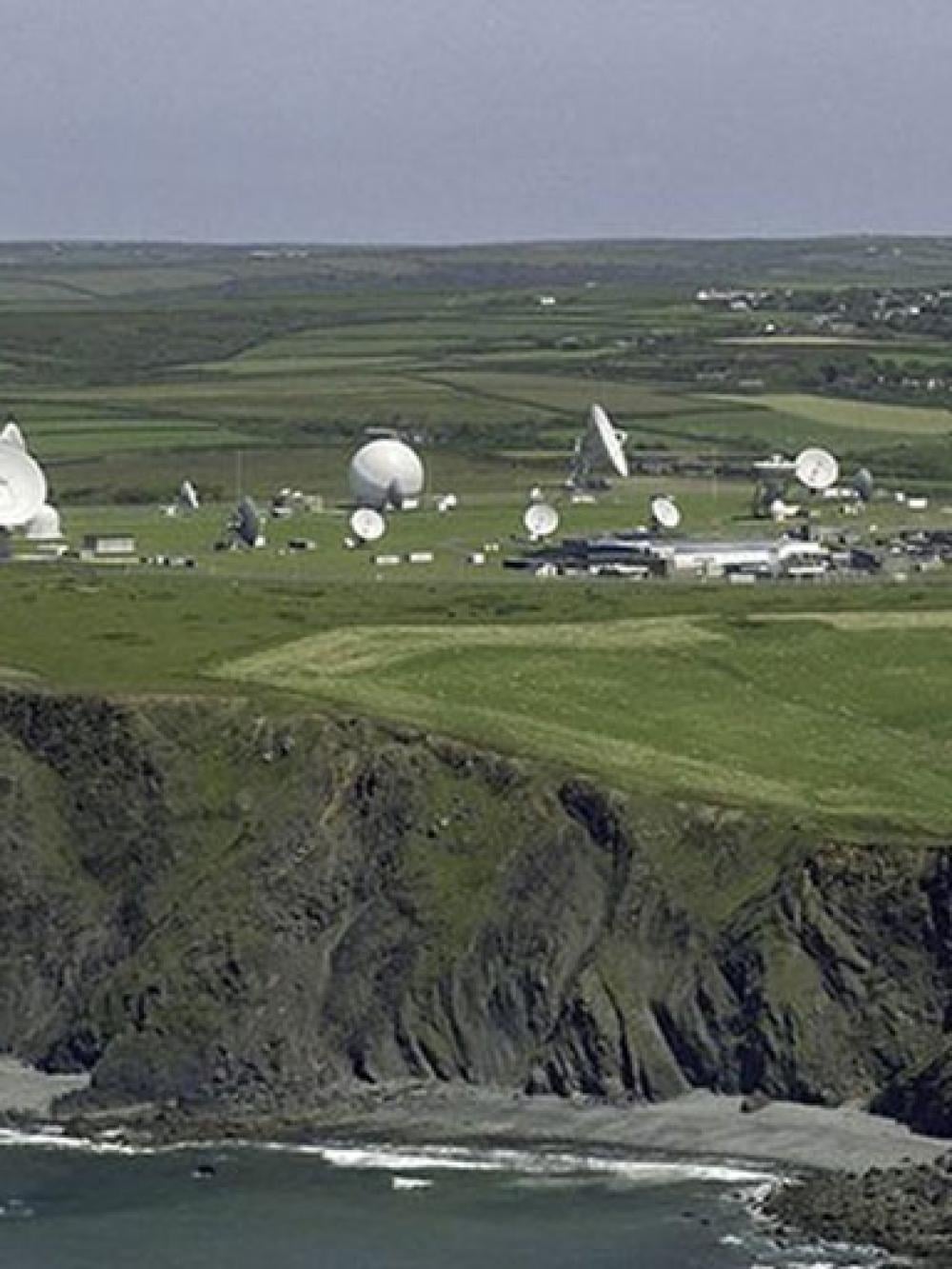 A general view photograph of our site at Bude. On hills sit satellite dishes and radomes.