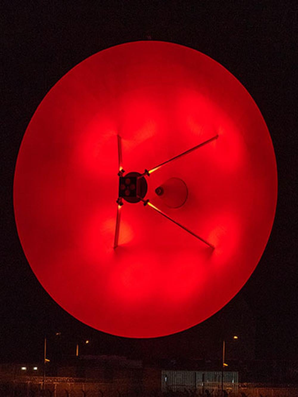 Satellite dish lit up at GCHQ Bude in November 2020