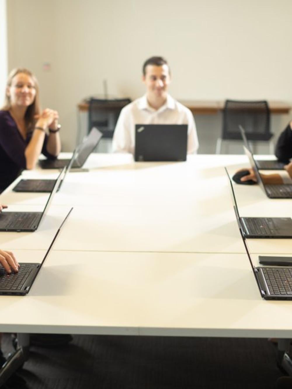 A group of people around a meeting table