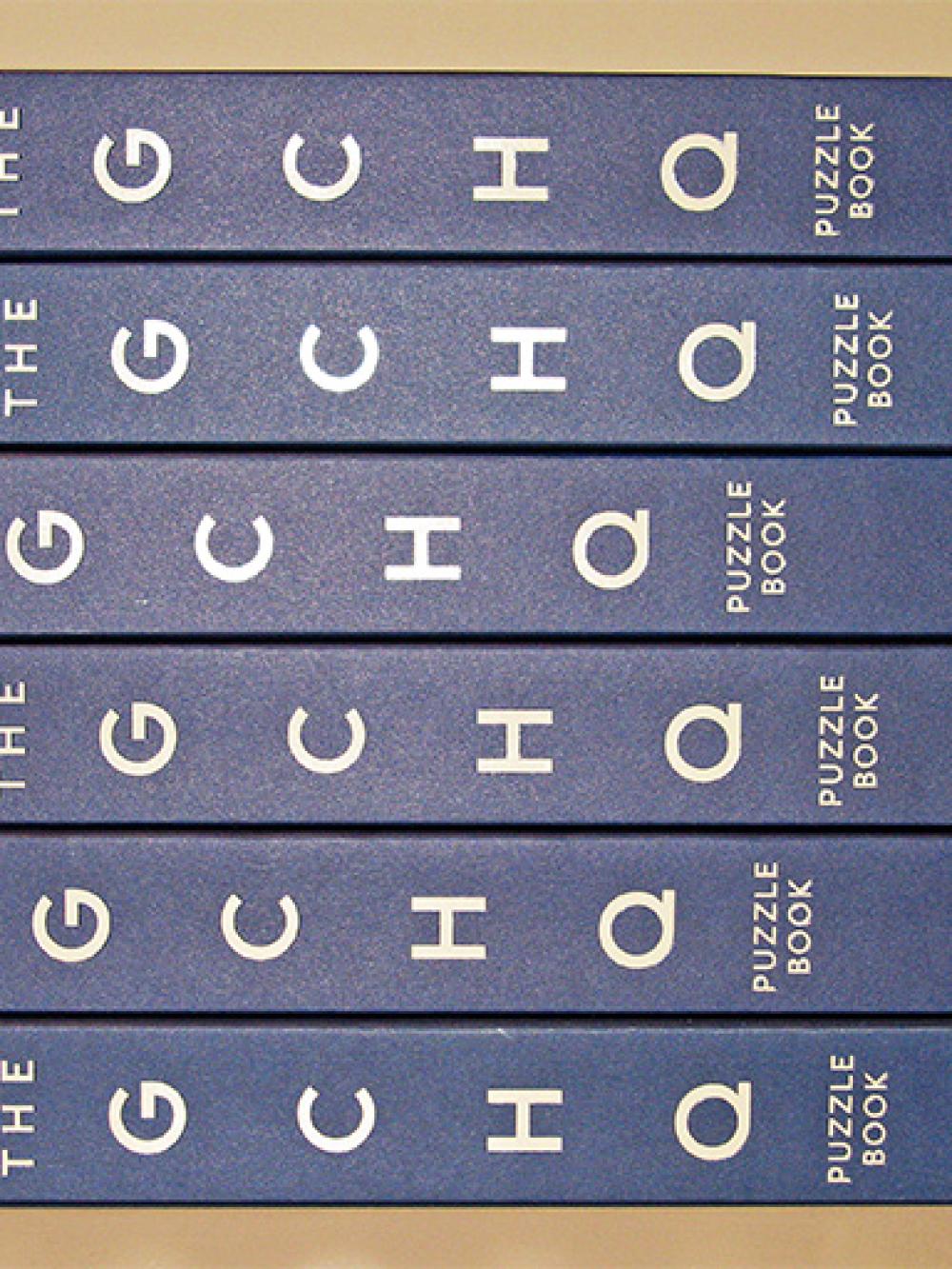 A pile of GCHQ Puzzle Books on their side