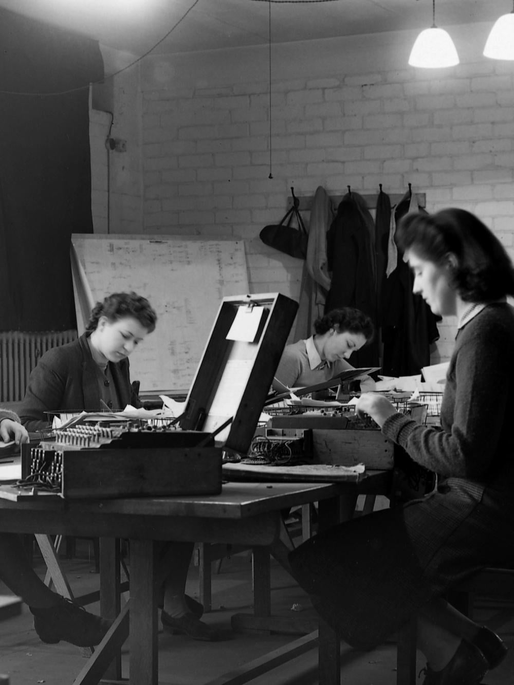 An image from Bletchley Park of three female codebreakers at work