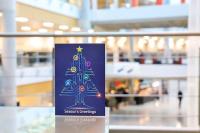 The 2021 Christmas Card sits on a table