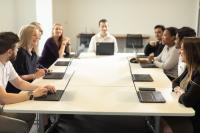 A group of people around a meeting table
