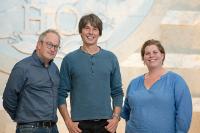 Robin Ince, Brian Cox and Katy Brand in front of the GCHQ crest