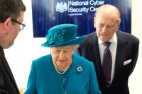 Former GCHQ historian Tony Comer displays artefacts to Her Majesty the Queen, and His Royal Highness the Duke of Edinburgh