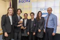 Students from the Perse School holding the National Language Competition trophy next to GCHQ Director Sir Jeremy Fleming