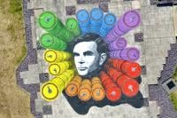 A birds-eye view of the Alan Turing artwork which features his portrait in the centre, surrounded by rainbow-coloured drums