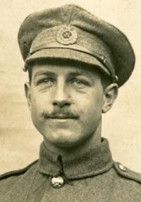Man with moustache, in WWI army uniform and hat