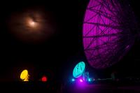Satellite dishes at GCHQ's Bude station lit up in colours of the Pride flag