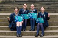 Competitors for the Cyber First competition 2019 launched by the National Cyber Security Centre sat on steps