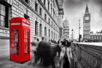 A bright red London telephone box in the foreground to Westminster bridge, with Big Ben in the background