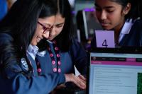 A young schoolgirl pressing a button in a Cyber First session